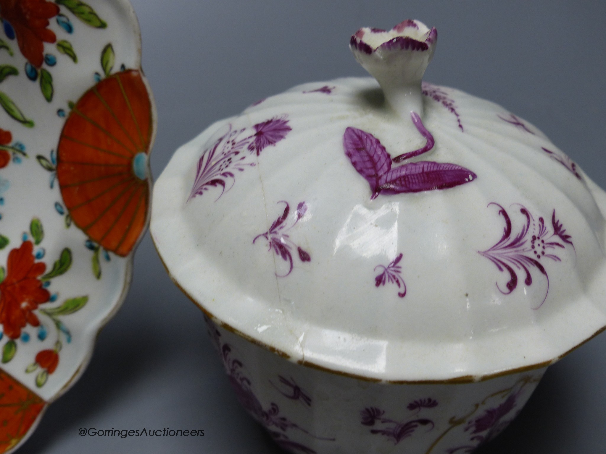 A Worcester plate painted with a very rare Scarlet Japan pattern with blue rock, diameter 20cm, and a Worcester sucrier and cover in a puce Meissen style pattern